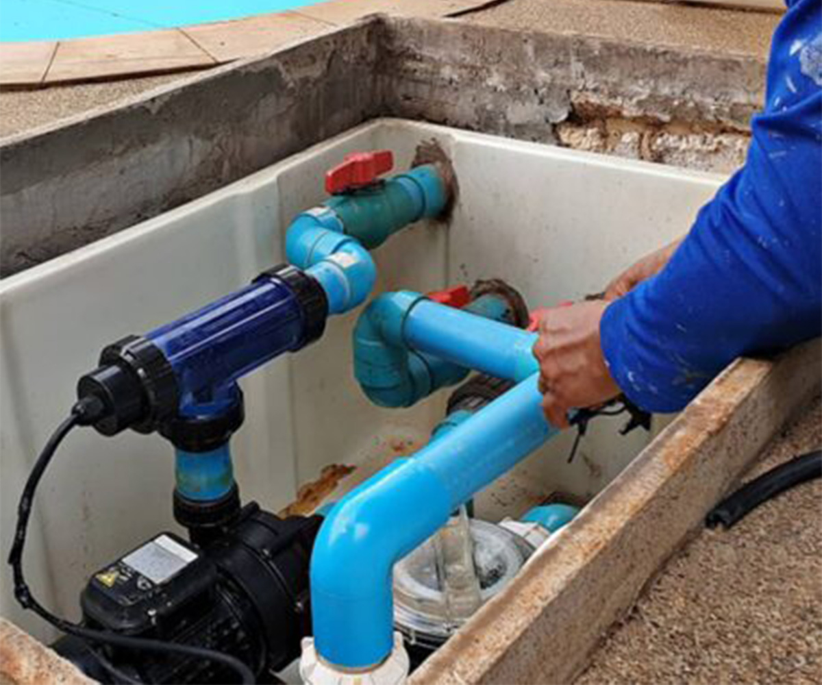 Pool pump repairs Cape Town - technician fitting new pump plumbing
