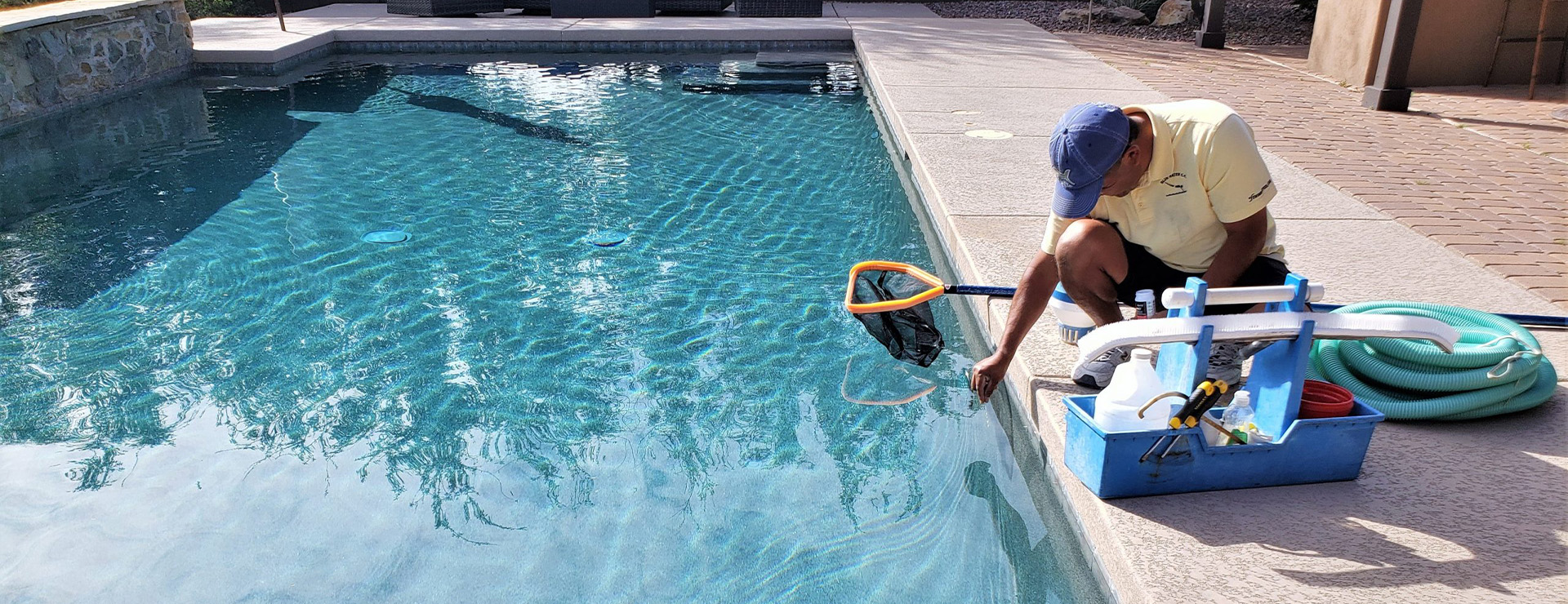 Pool cleaning services Cape Town - technician servicing a pool