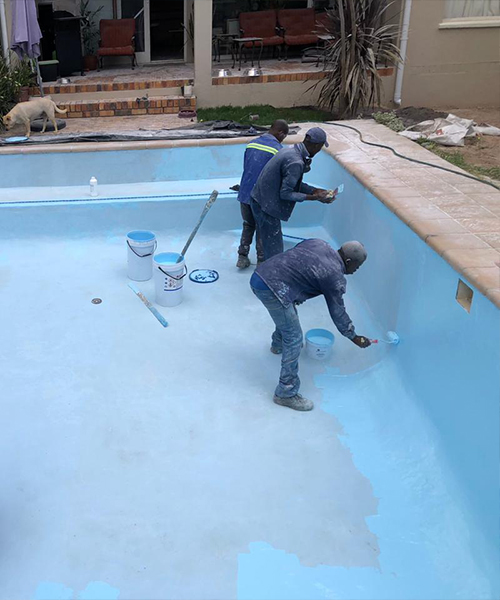 Marbelite pool resurfacing - crew applying a new marbelite finish