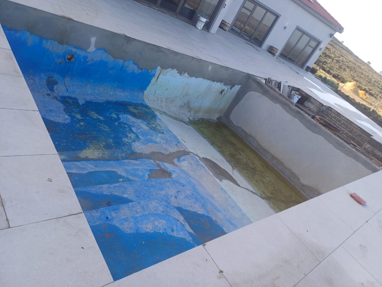 pool relining Cape Farms before — peeling marbelite and rough surface