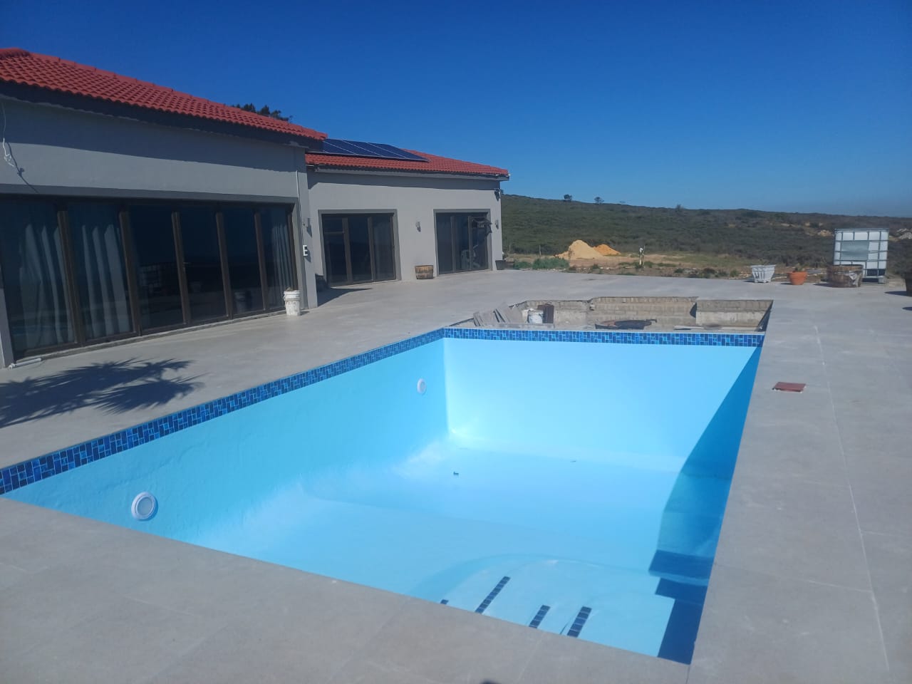 pool relining Cape Farms after — finished fibreglass pool with mosaic border