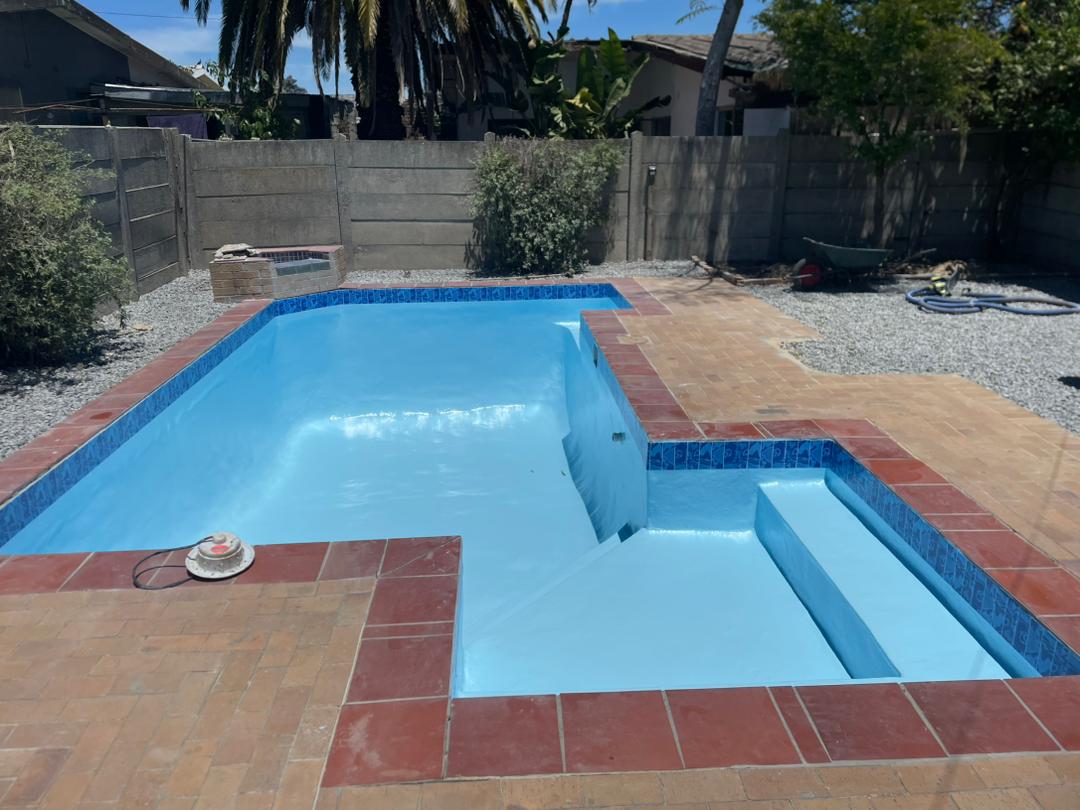 pool relining Kraaifontein after — finished pool with new paving and mosaic band