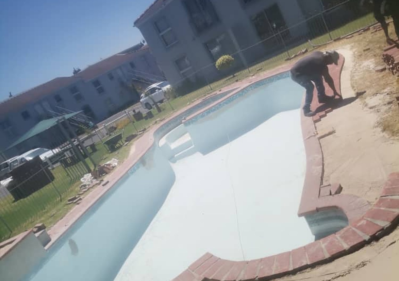 Pool leak detection Cape Town - technician inspecting an empty pool shell