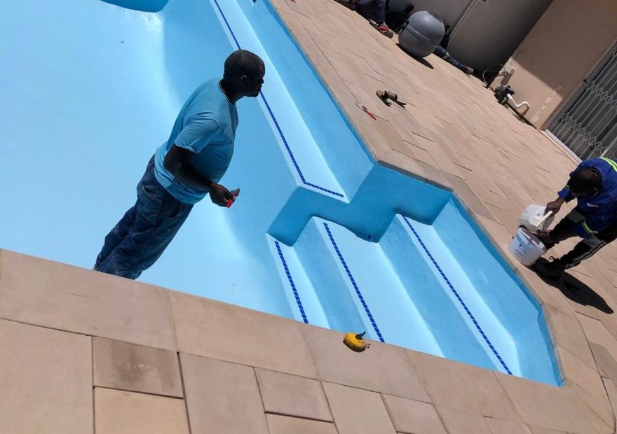 Pool relining Cape Town - freshly relined blue pool with crew at work