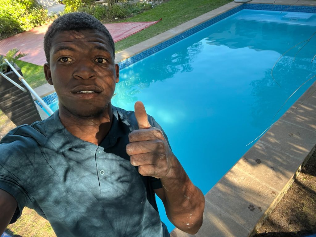 Gibbs Pools crew member thumbs up at finished pool