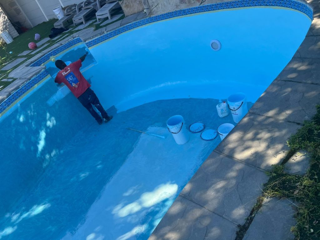 Pool Repairs & Relining in Clifton | Gibbs Pools Pool resurfacing Clifton: new blue gelcoat being applied