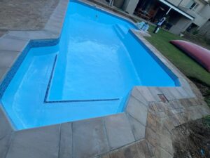 Completed gunite pool relining with fibreglass in Bellville, 10x5m with new copings, R78,800